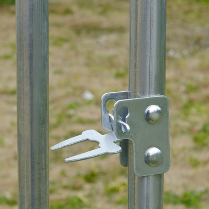 A close-up of the metal latch mechanism used to secure the door of the poultry house