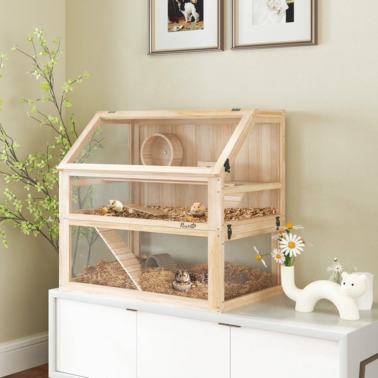The hamster hutch with two levels, a wheel, hut, seesaw and ramps, shown with two hamsters inside