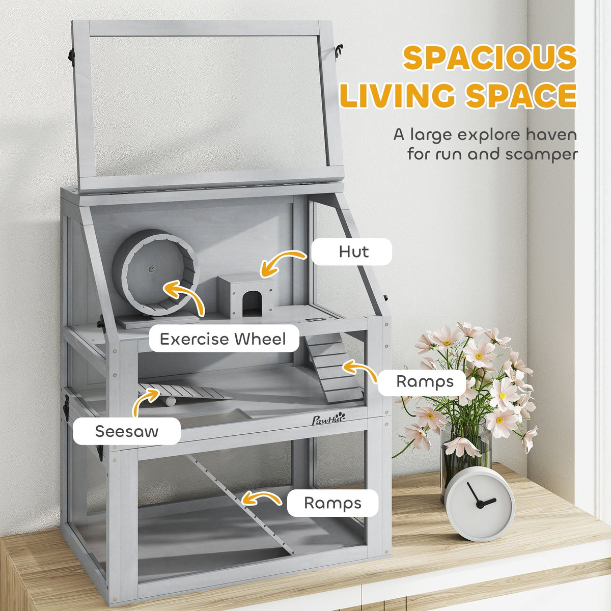 The wooden hamster cage with its features labelled, including hut, exercise wheel, seesaw and ramps