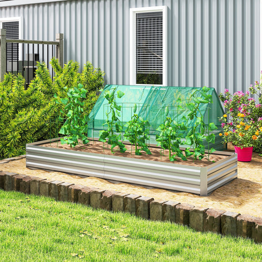 The metal garden planter filled with soil and green plants in a sunny outdoor garden setting