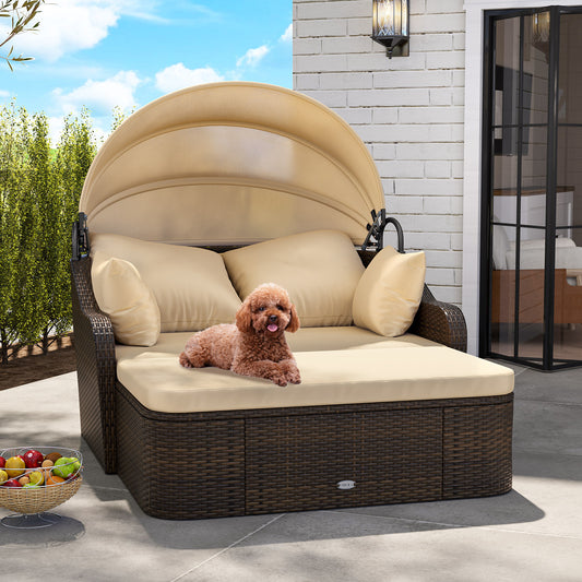 The brown rattan daybed with beige cushions and a retractable canopy, a small dog sits on top
