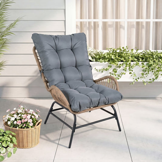 The PE Rattan Leisure Chair with cushion on a patio next to a basket of flowers