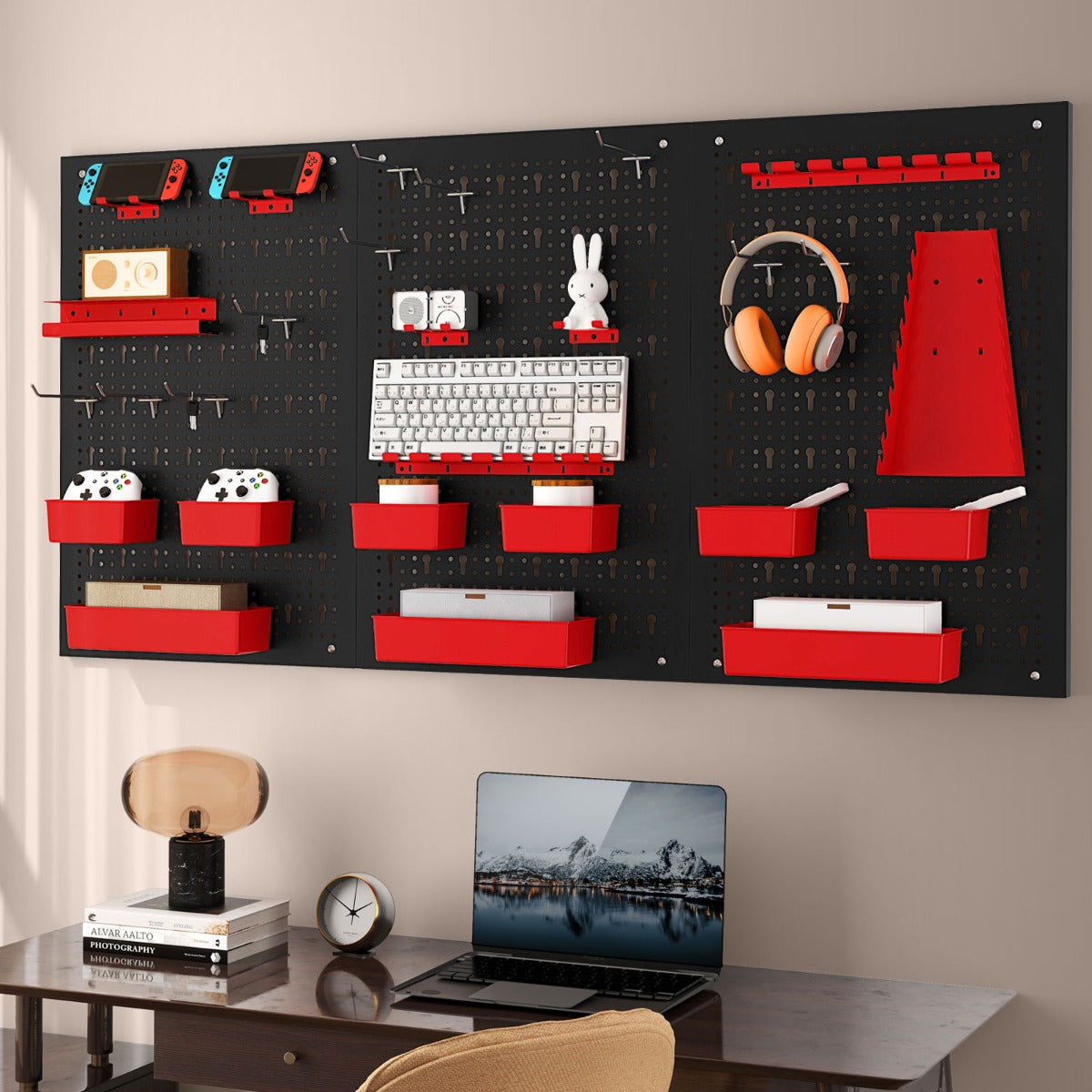 This pegboard wall organiser is set up in a home office with a laptop, headphones and gaming accessories