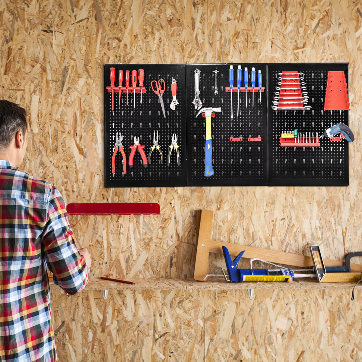 The garage pegboard organizer being used by a person selecting tools