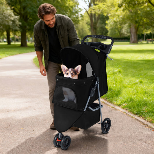 Man pushing the black pet stroller with an inquisitive dog inside on a sunny park path