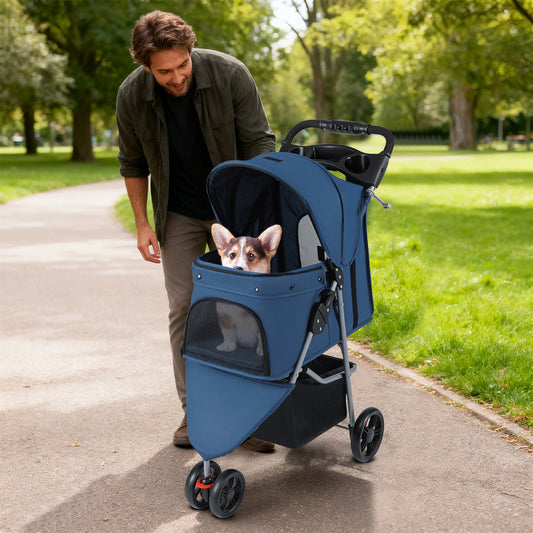 The navy pet buggy being pushed by a man along a path in a park with a dog inside