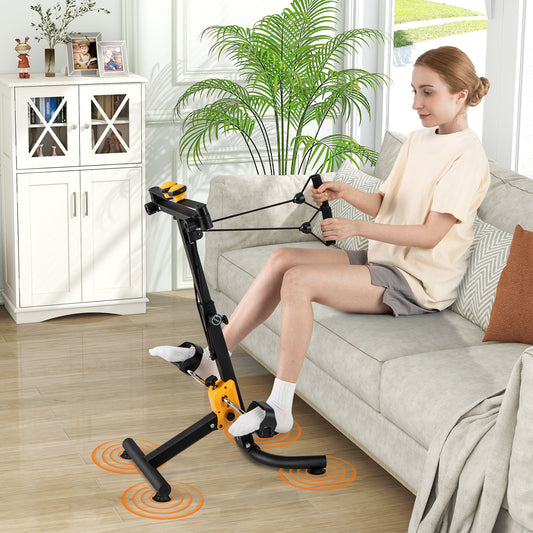 Woman using the yellow exercise bike while sitting on a sofa in a living room