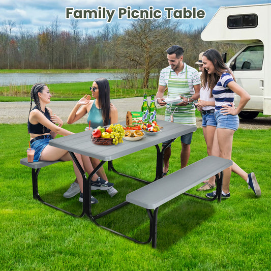 Family picnic table set with four people sitting and eating outdoors