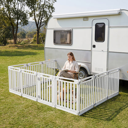 The plastic pet fence set up outdoors next to a caravan with a person sitting inside