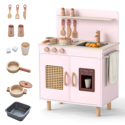 The pink play kitchen set with cooking accessories laid out