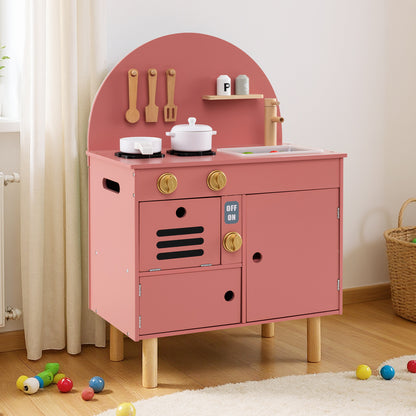 The pink wooden play kitchen set with accessories on a rug