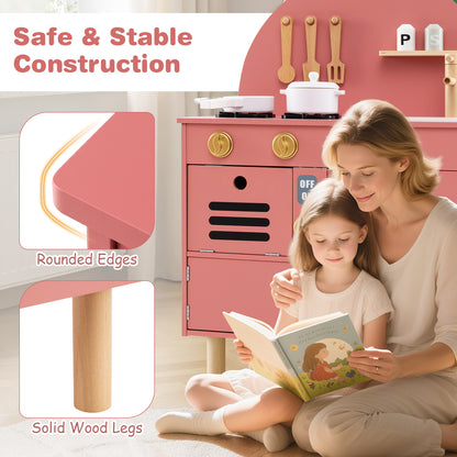A mother and child read a book next to the safe and stable construction of the play kitchen set