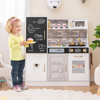 A young girl holding a toy cupcake while standing next to the play kitchen set