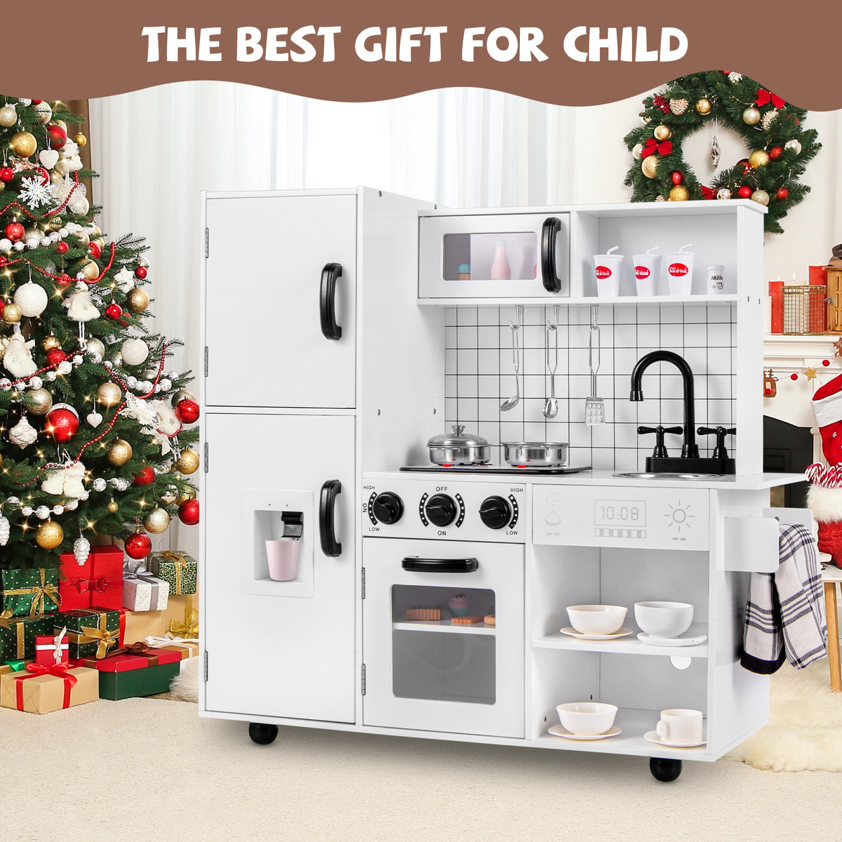 The white toy kitchen set placed in a living room next to a decorated Christmas tree