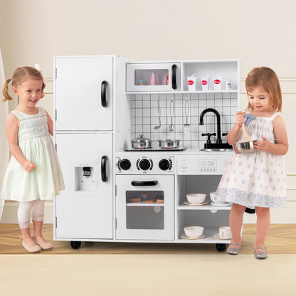 Two young girls playing with the white toy kitchen set in a home environment