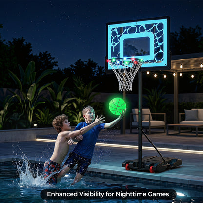 Two boys playing with the glowing basketball hoop in a swimming pool at night