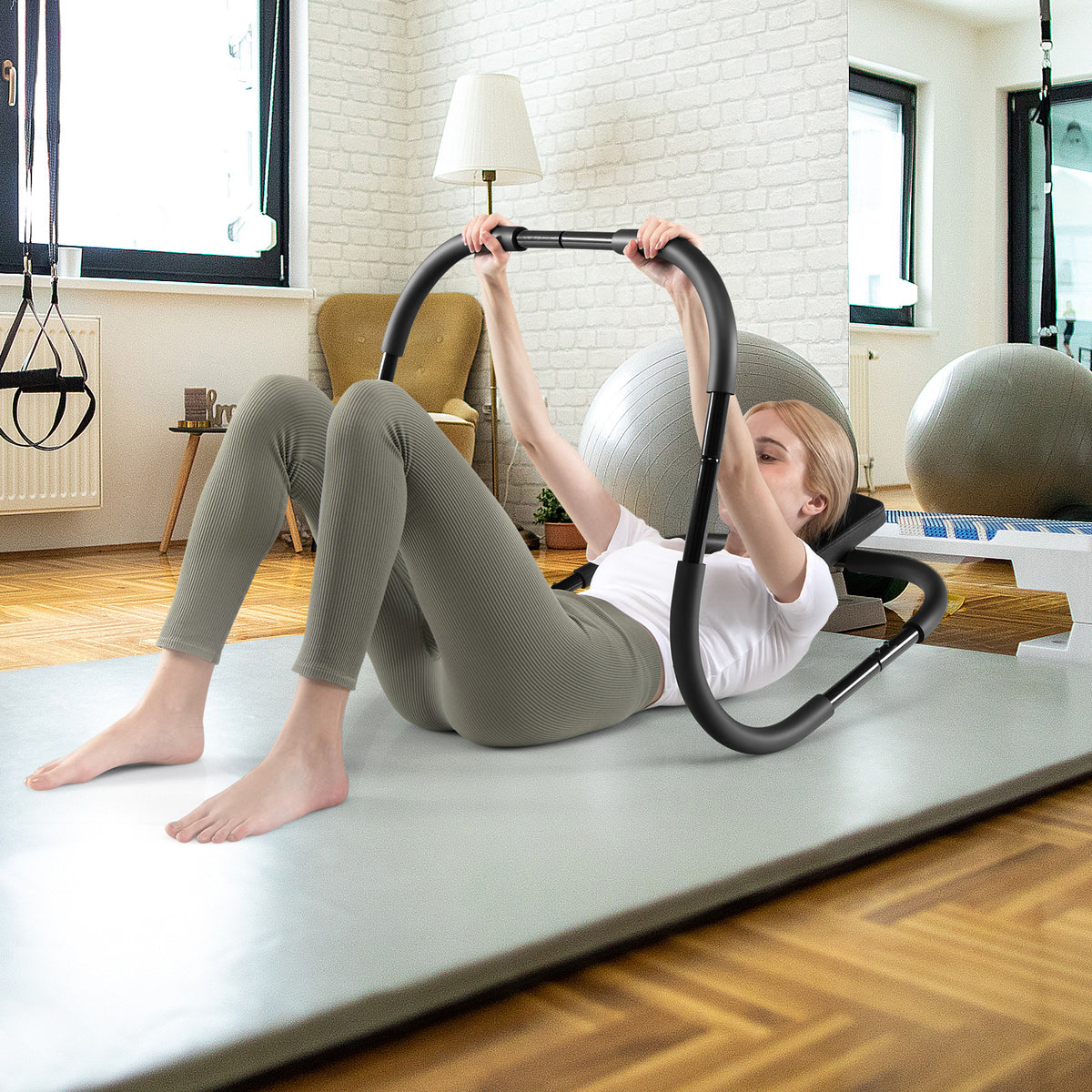 Woman using the portable AB trainer with padded headrest on a yoga mat in a bright room