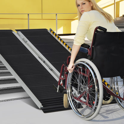 A woman in a wheelchair uses the portable aluminum wheelchair ramp to go up steps