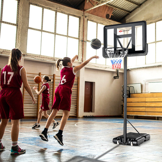 The portable basketball hoop in use by young players on an indoor court