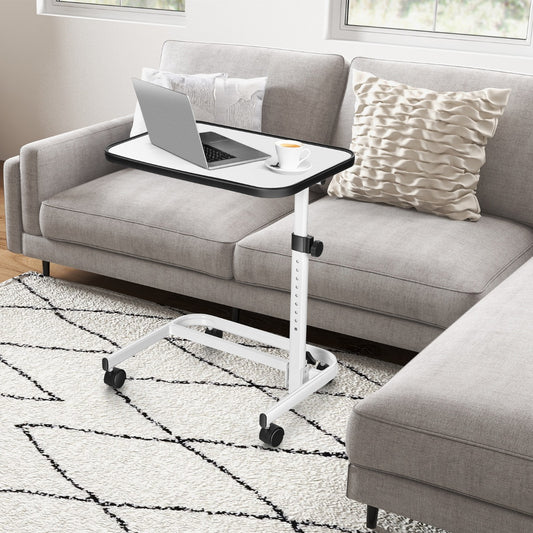 The side table placed next to a grey sofa with a laptop and a cup of coffee on top