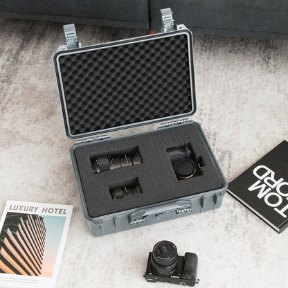 The camping case open on a rug holding camera lenses and a camera body