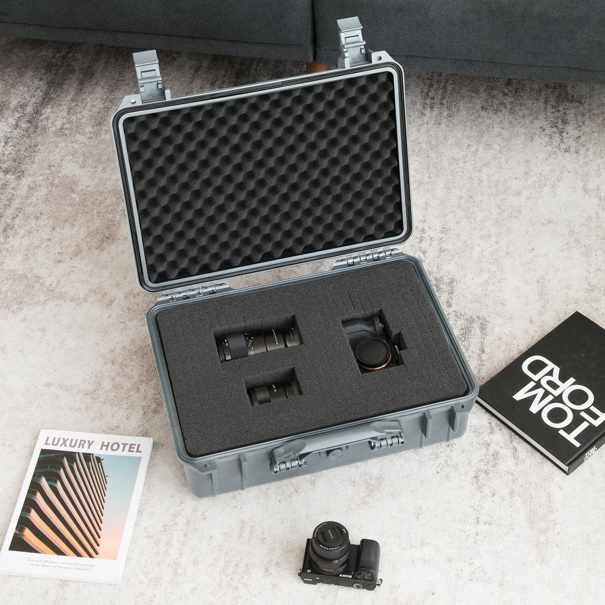 The grey camping case is shown with a camera and lenses inside