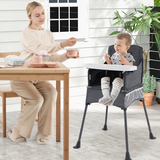The feeding chair in use by a toddler sitting at a wooden dining table