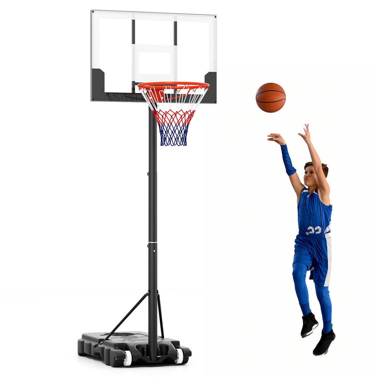 Young boy in a blue basketball kit shooting hoops with the portable basketball hoop