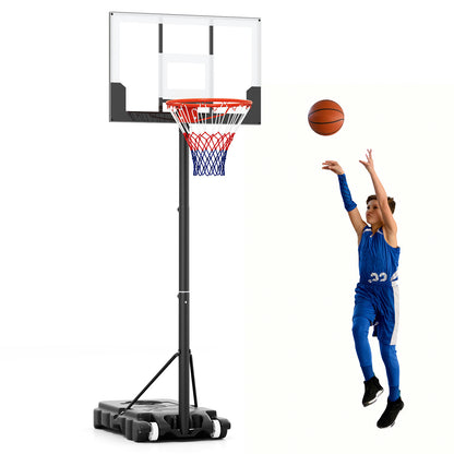 Young boy in a blue basketball kit shooting hoops with the portable basketball hoop