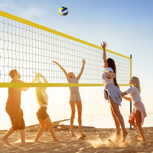 People playing volleyball on a beach with the yellow net system
