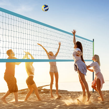 the volleyball net system set up on a sandy beach with a blue and yellow ball in the air