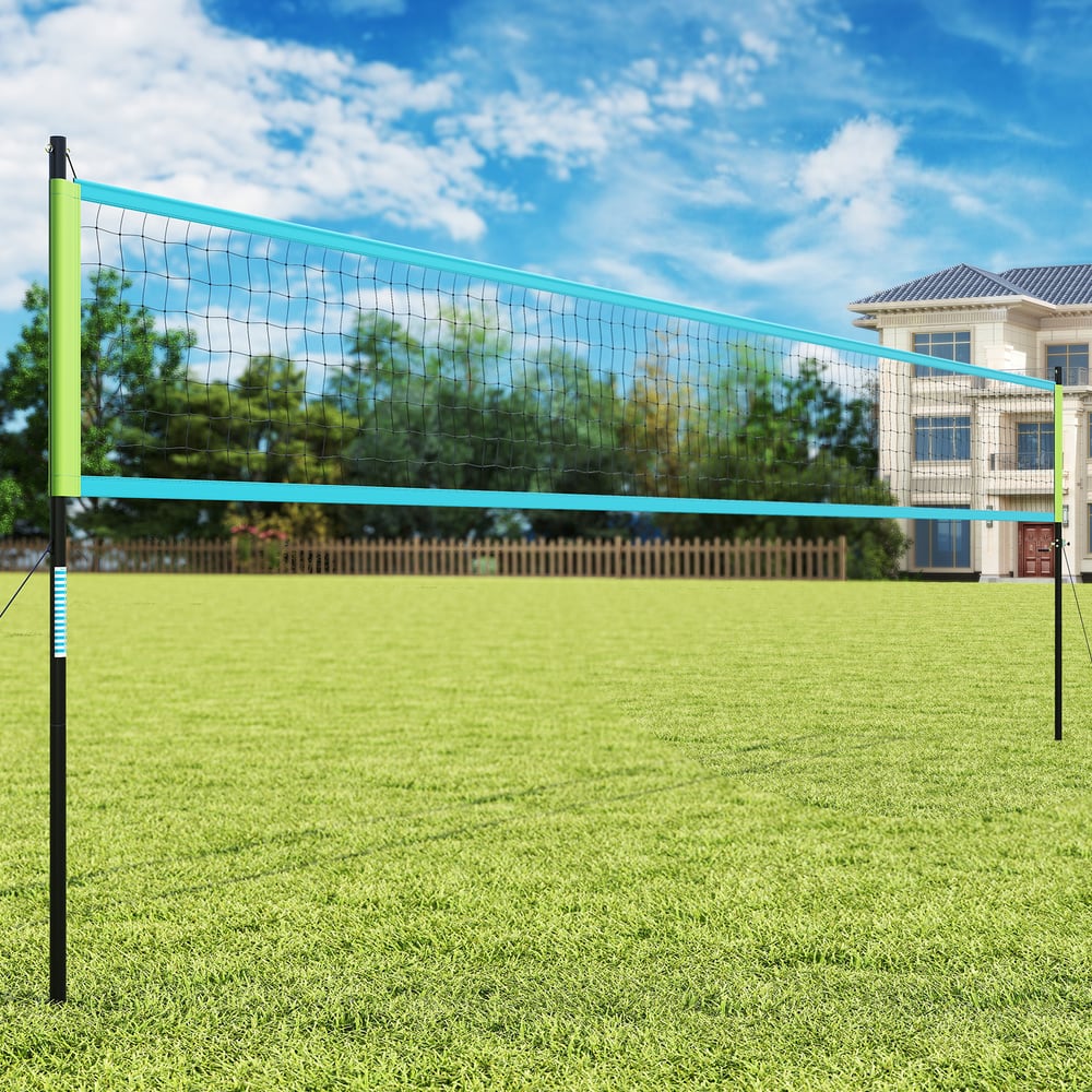the volleyball net system standing on a grassy field in front of a residential house