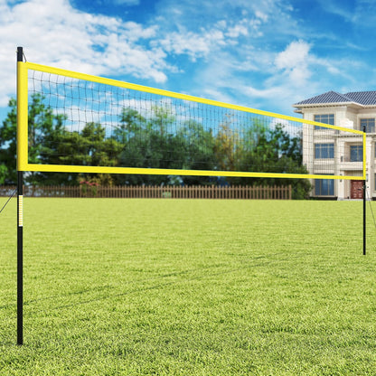 The yellow volleyball net system set up on a green lawn