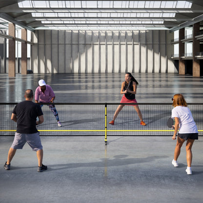 Portable Regulation Size Pickle Ball Net System, the sport equipment placed in a large indoor hall with people playing