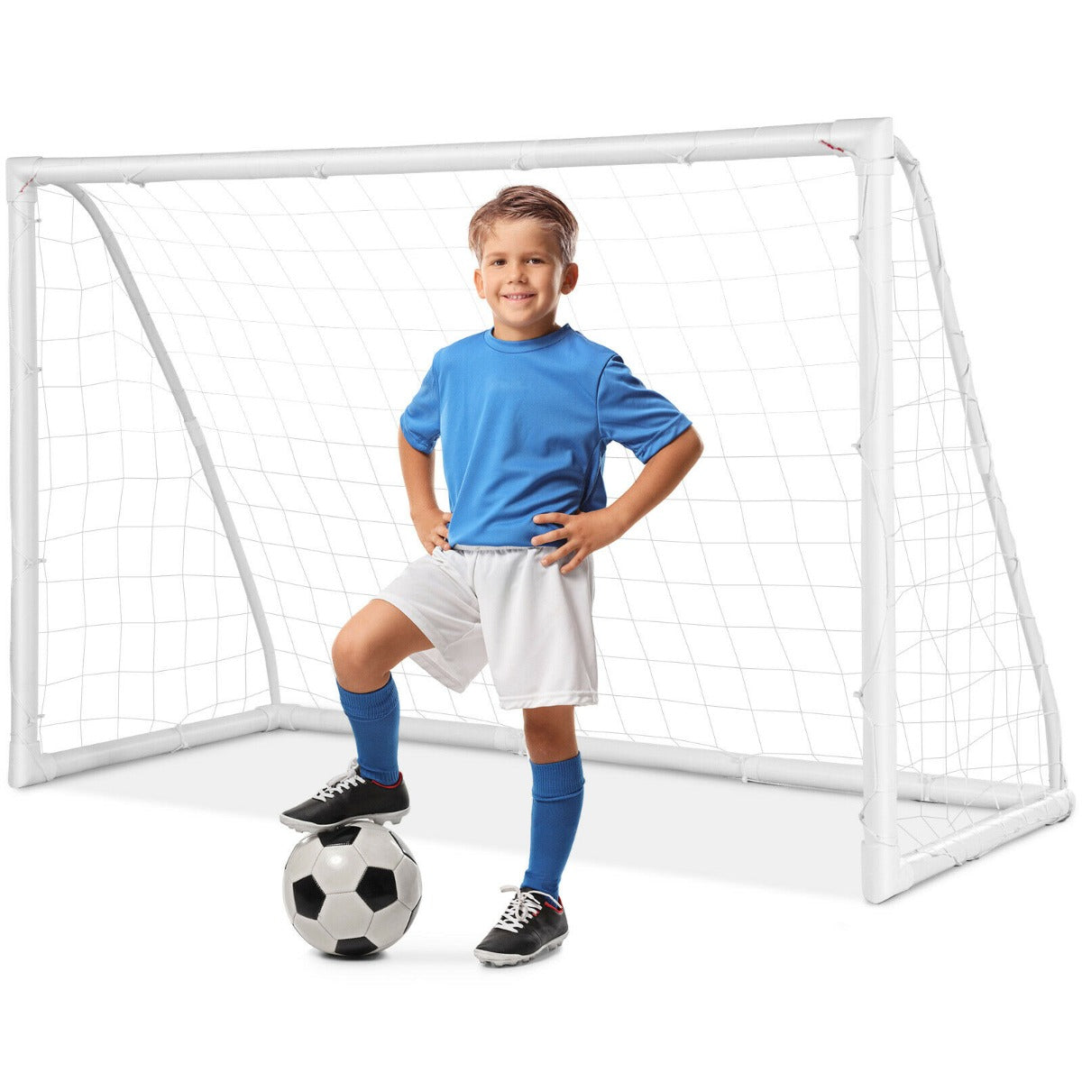 The soccer goal with a young boy standing proudly with his foot on a football