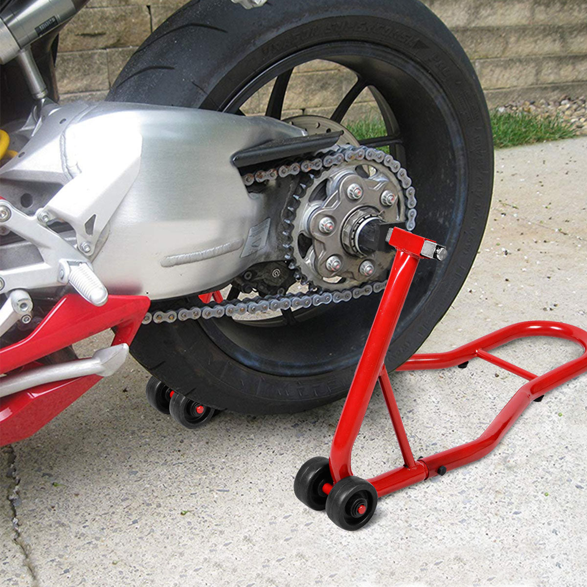 Close-up of the red motorcycle stand supporting a sport bike's rear wheel and chain