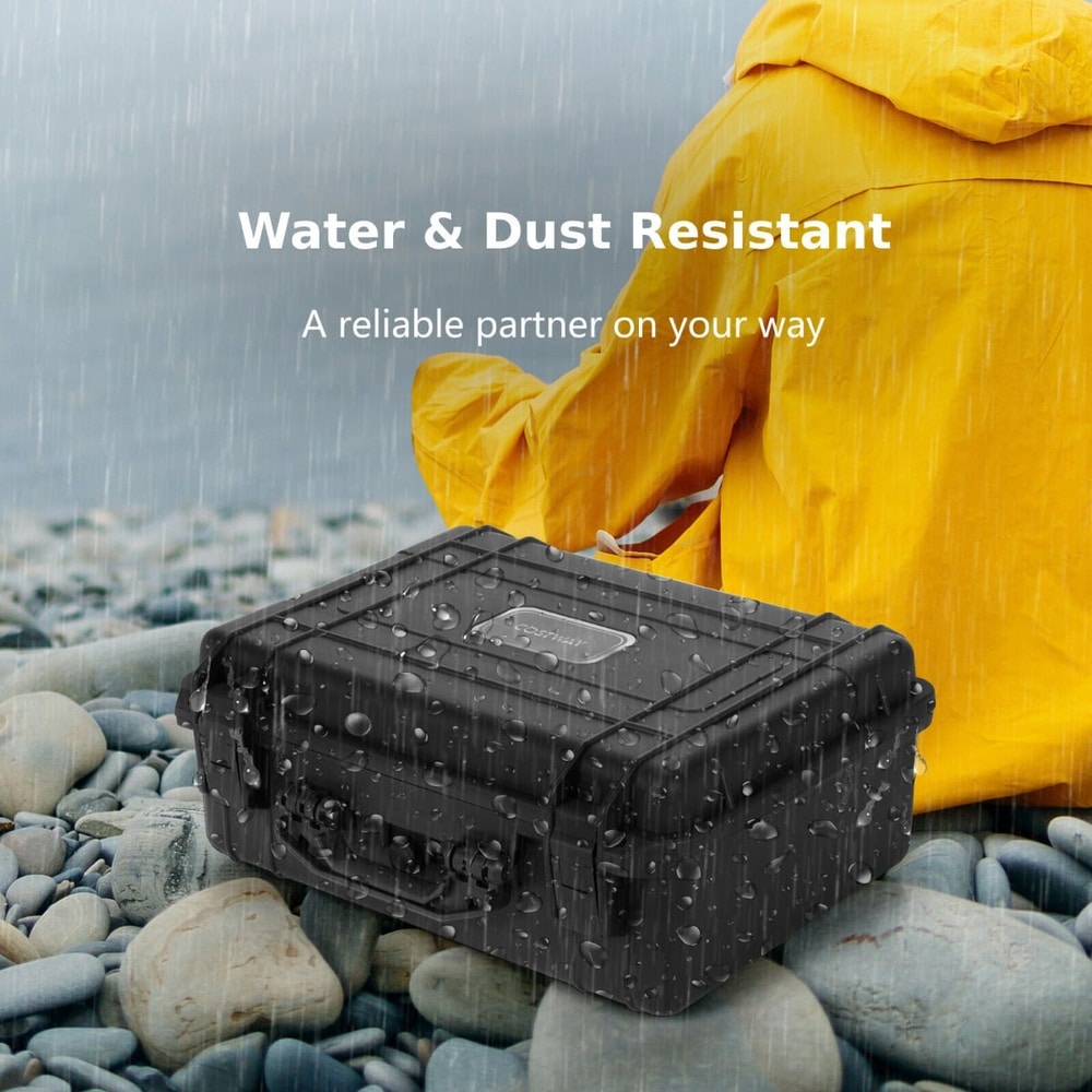The portable waterproof hard case sits on a wet pebble beach
