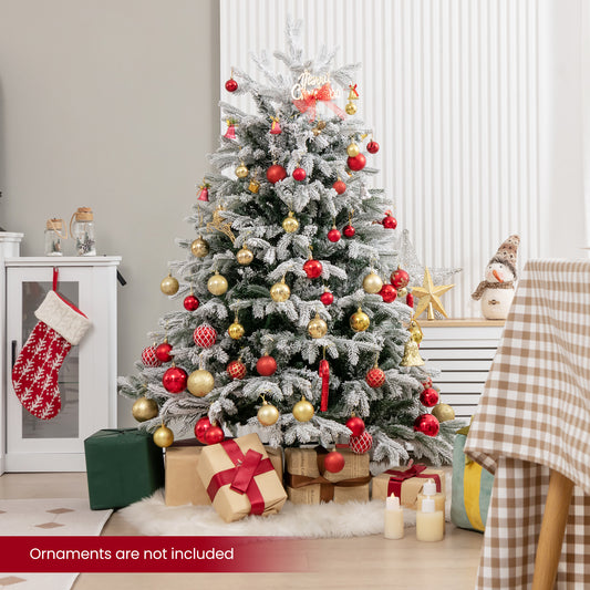 Decorated Christmas tree with baubles, gifts and stockings in a cosy room setting