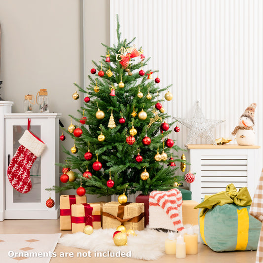 The Christmas tree decorated with red and gold baubles in a festive living room setting