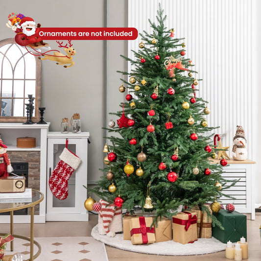 The Christmas tree decorated with baubles, presents underneath and a snowman nearby