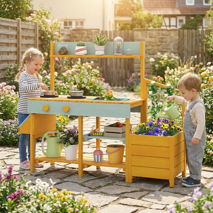 Two children playing with the yellow mud kitchen in a garden setting