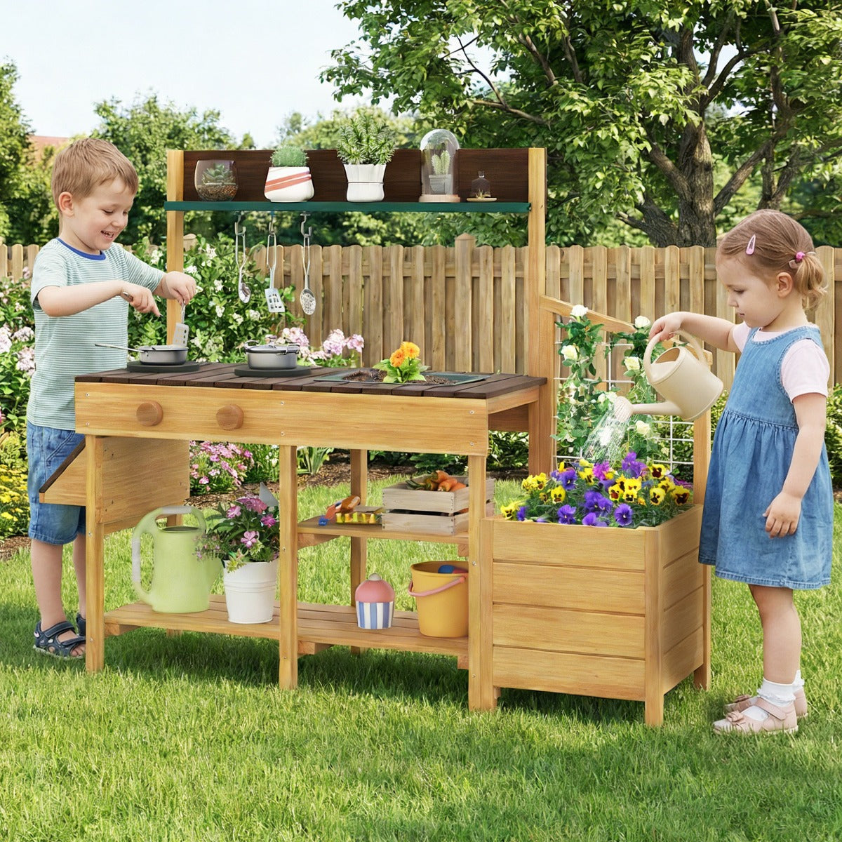 Two children playing with the wooden mud kitchen set in a garden setting