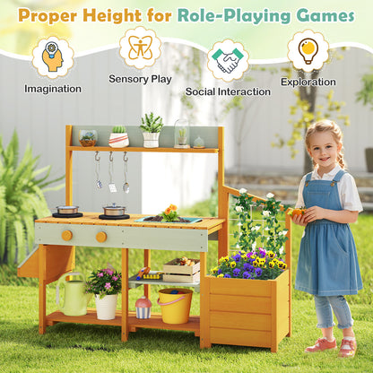 Girl standing next to the yellow mud kitchen play kitchen, highlighting role-playing features