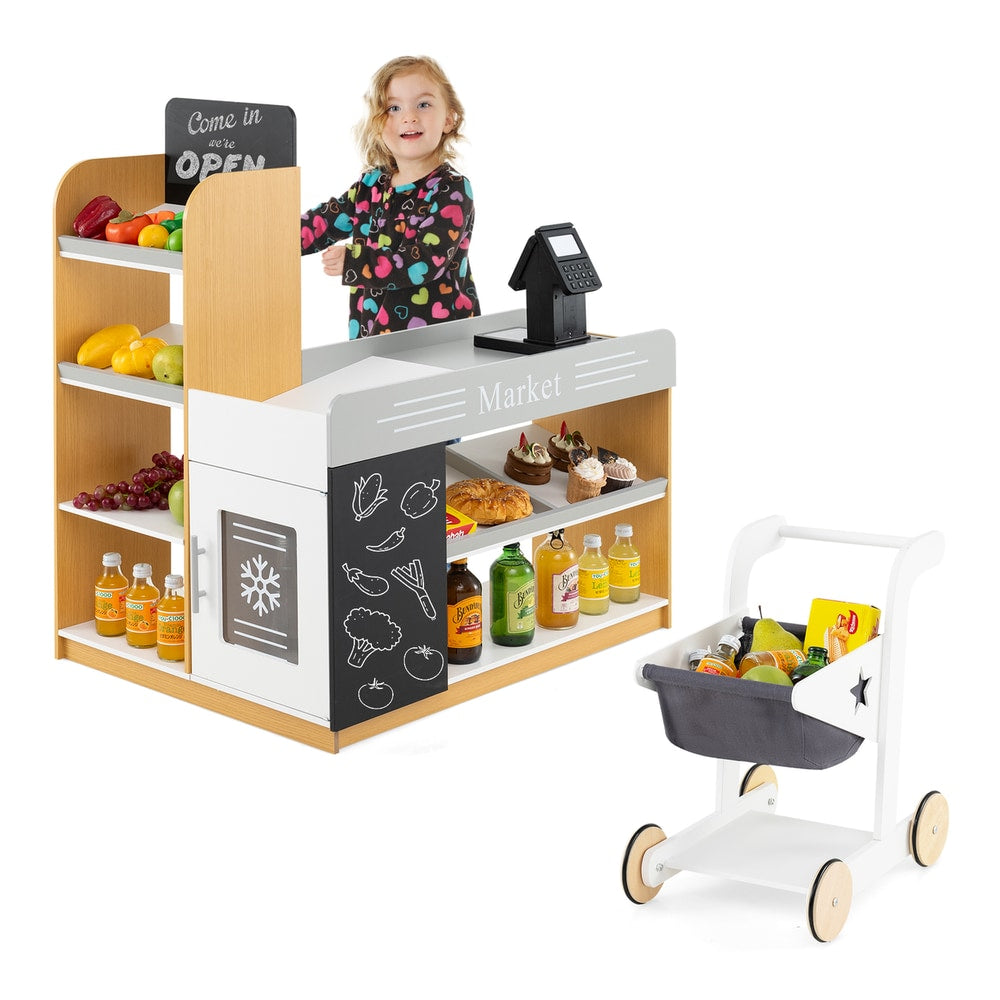 Girl standing behind the toy grocery store counter with shopping cart