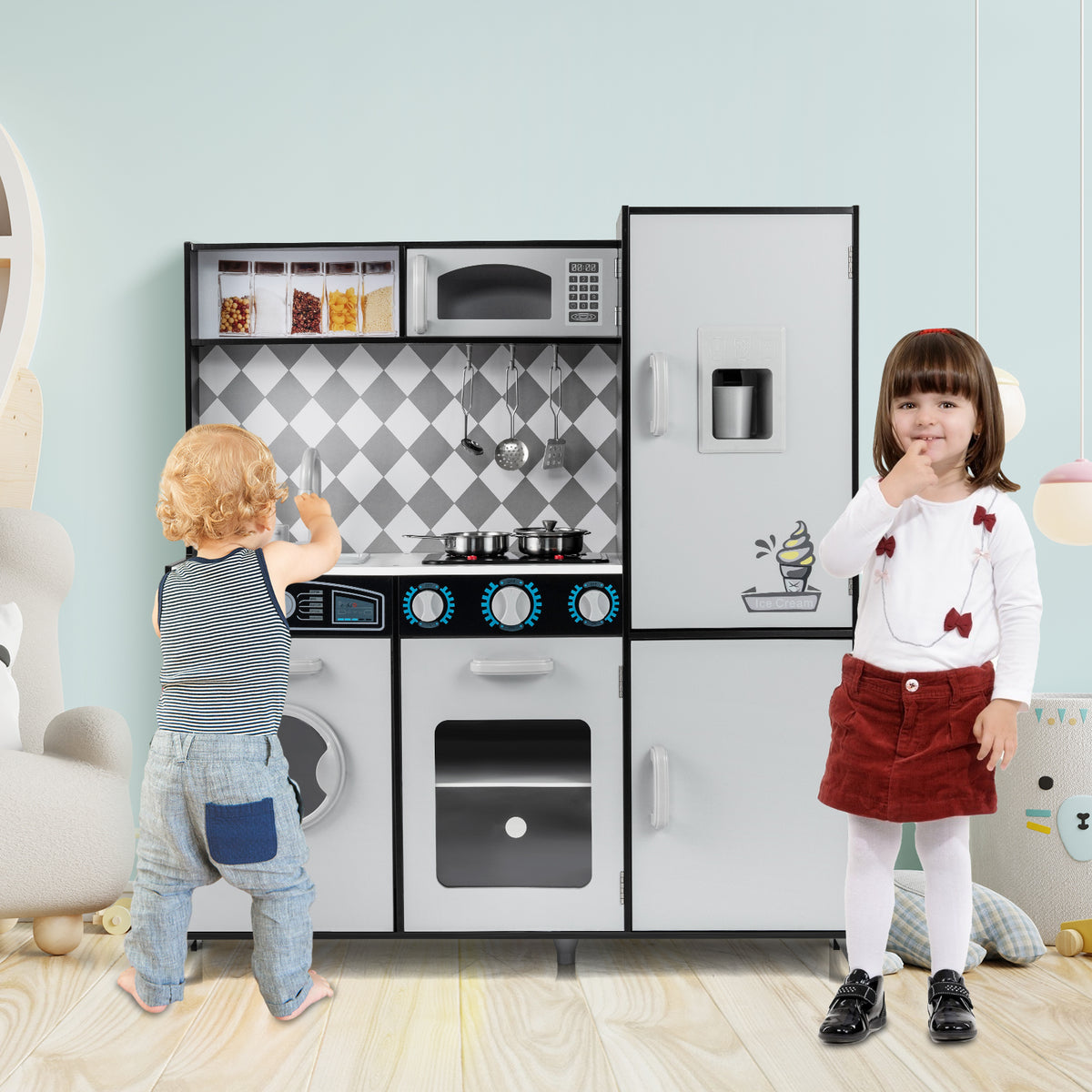 The play kitchen set being used by two young children in a bright and airy playroom