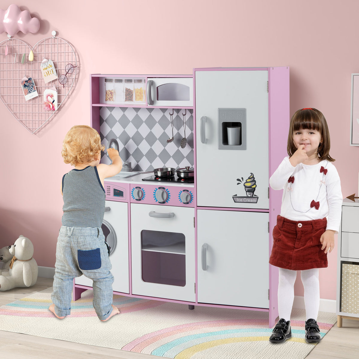 Children playing with the pink pretend play kitchen set
