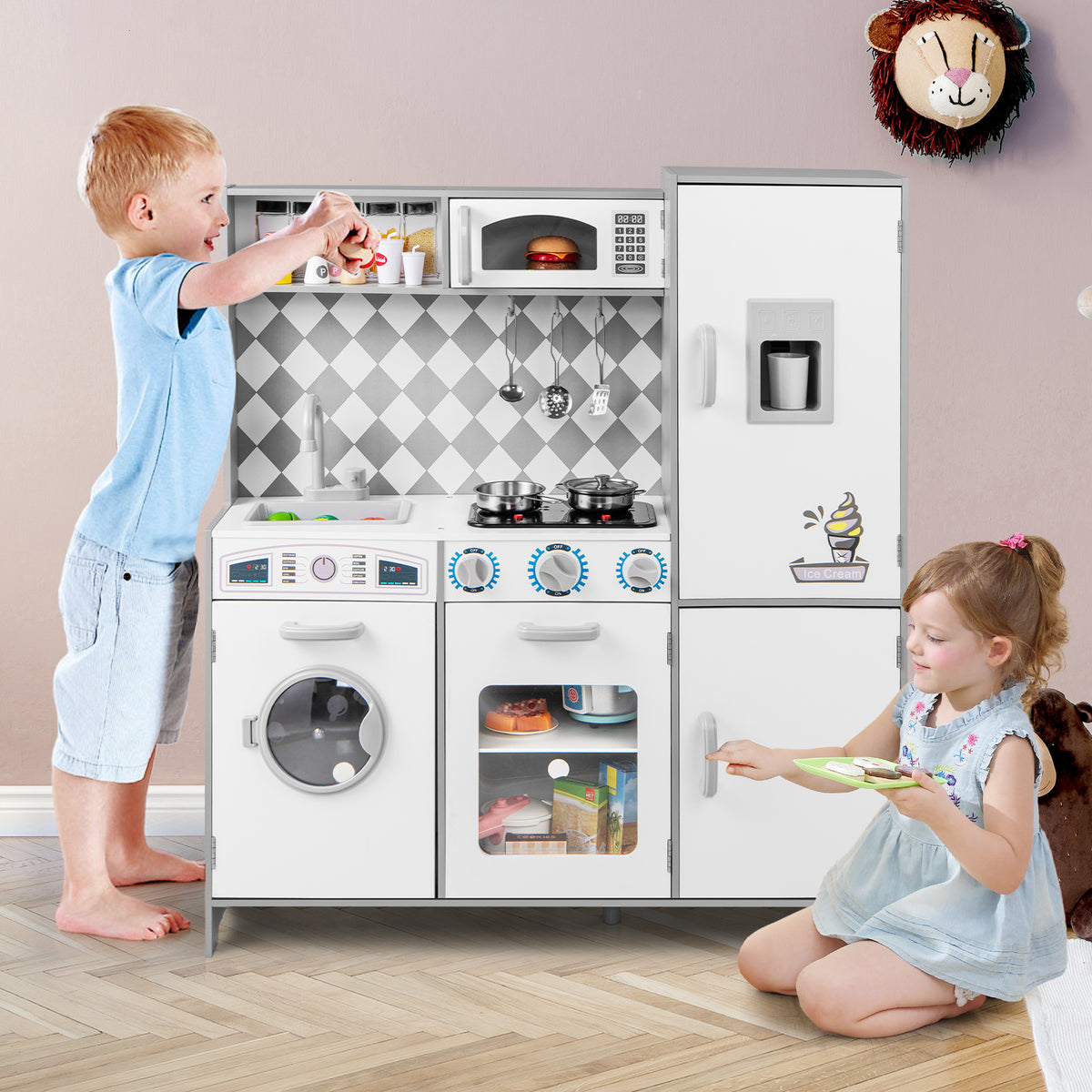 Two children playing with the white pretend play kitchen set