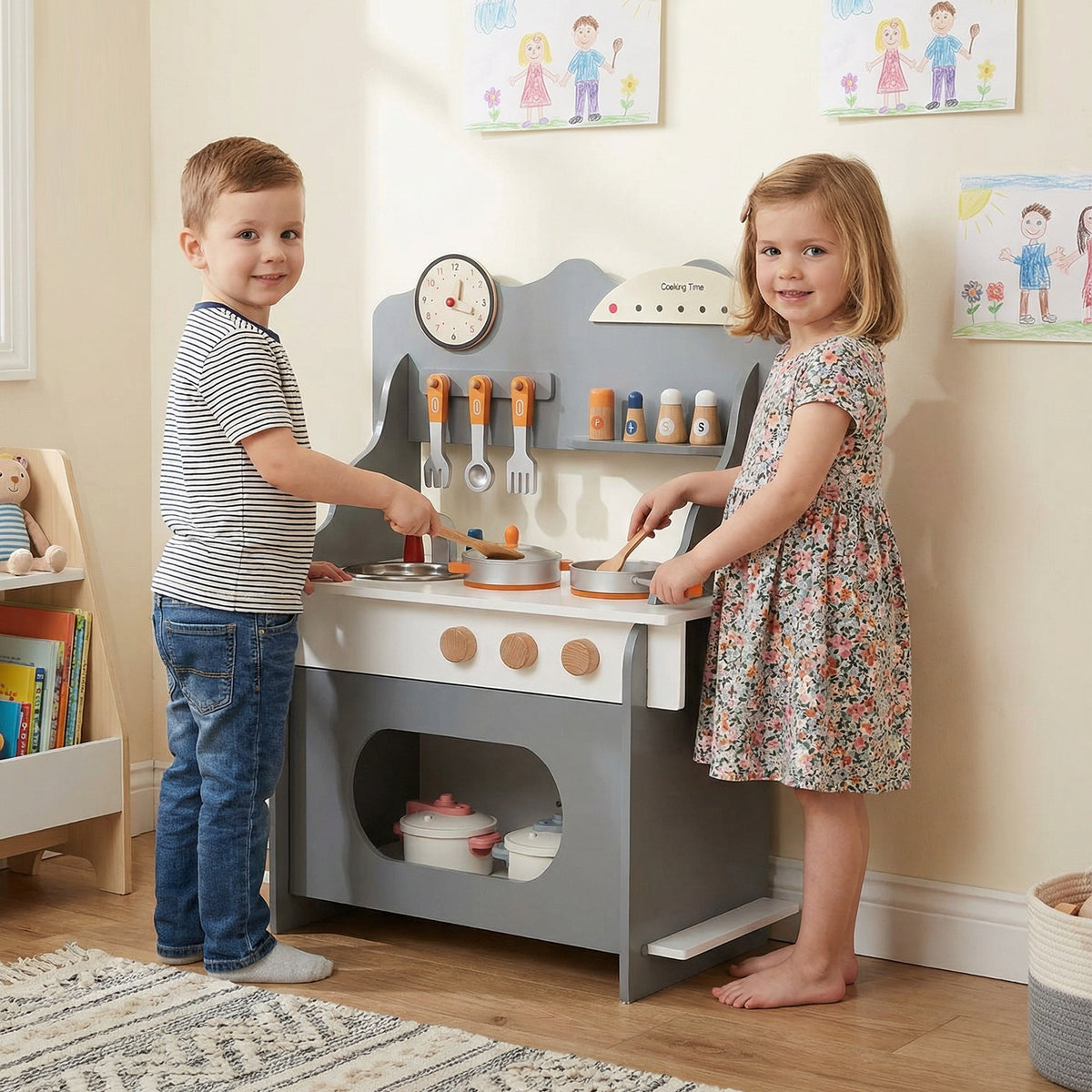 Two children playing with the grey toy kitchen set