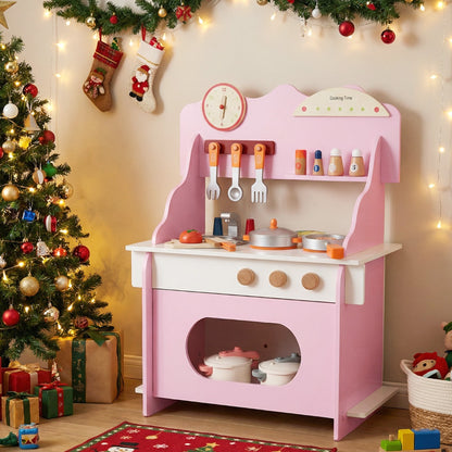 The play kitchen set placed next to a decorated Christmas tree with fairy lights in a room