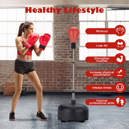 A woman in red boxing gloves uses the red punching bag with stand for a workout